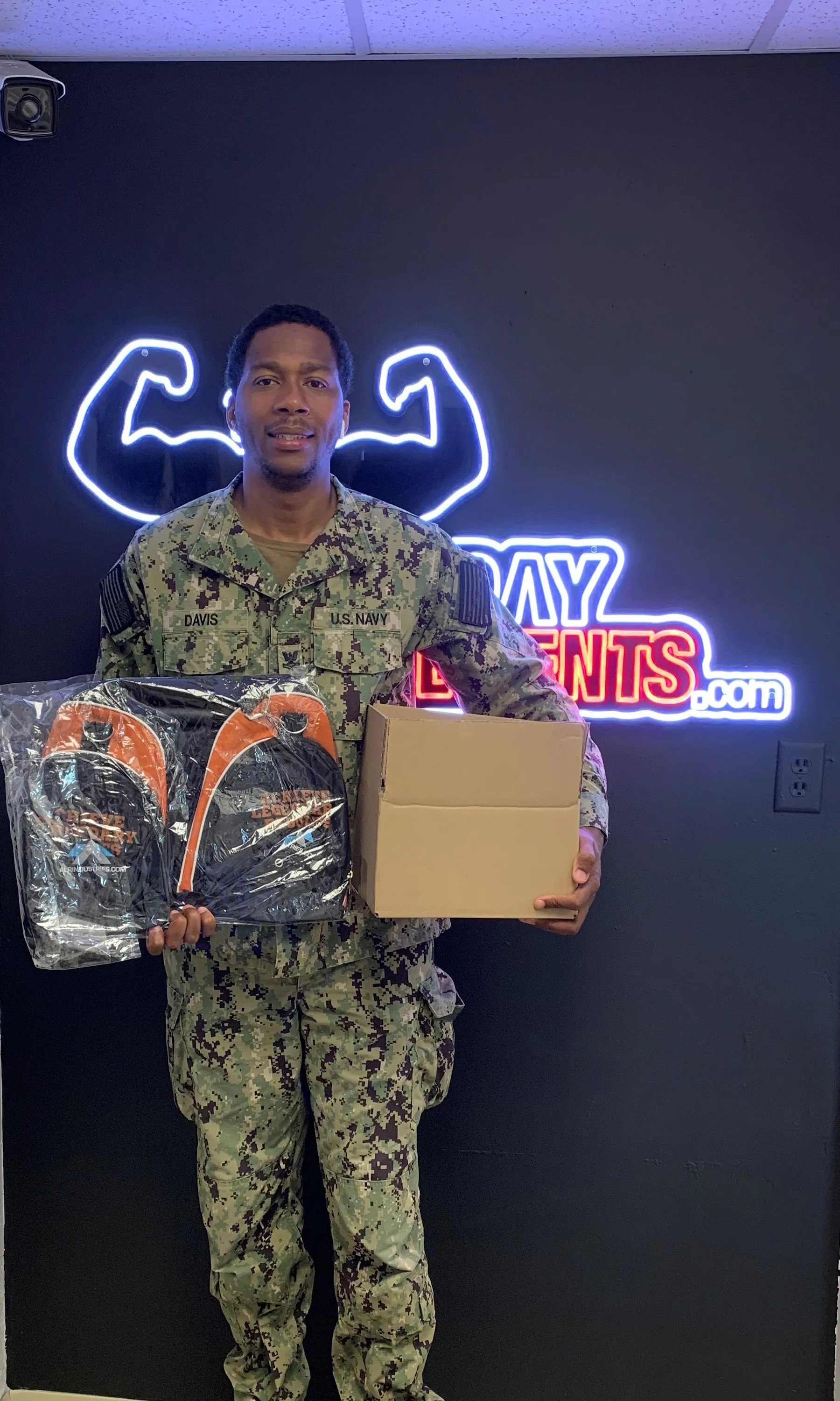 U.S. Navy member picking up supplement and swag bag