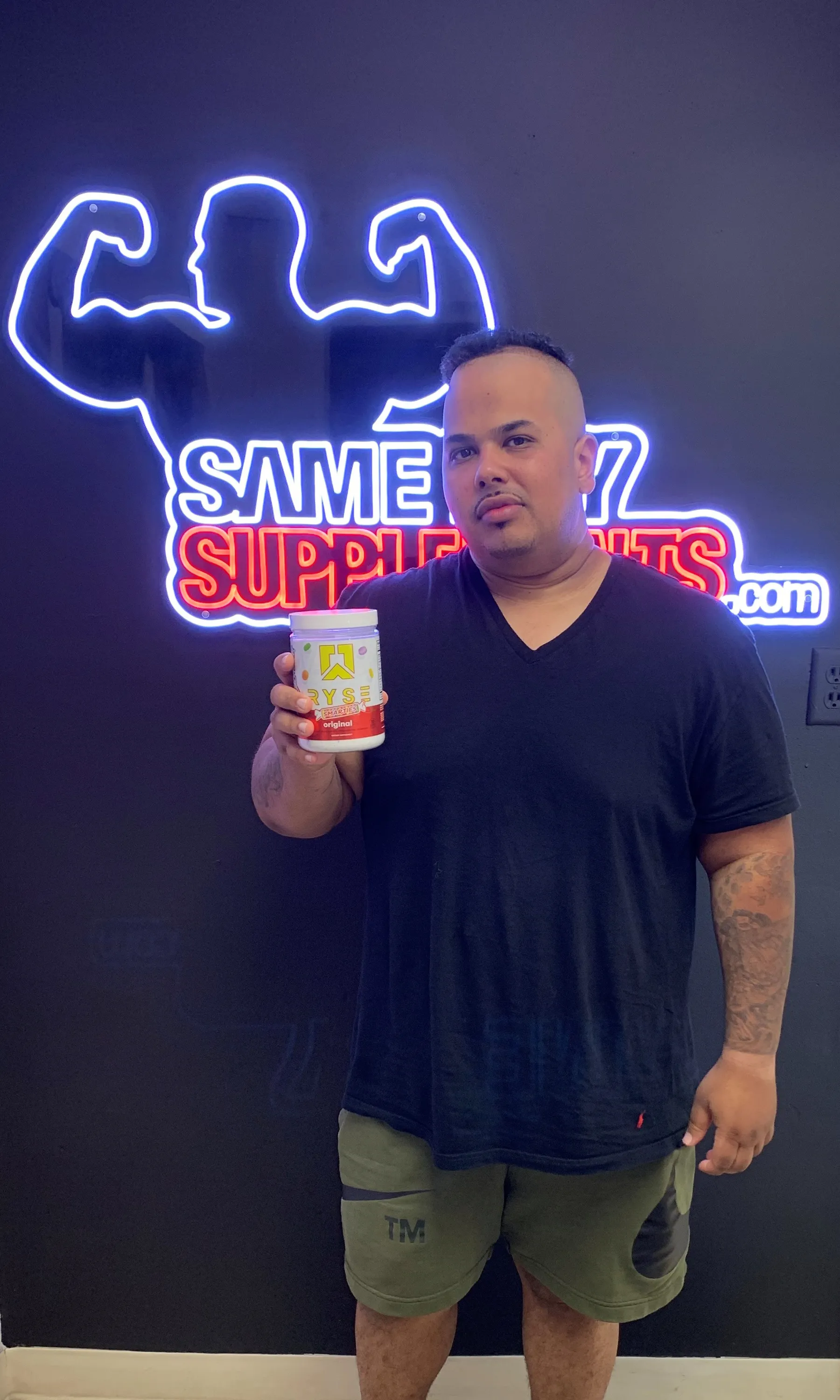 Customer holding RYSE Loaded Protein tub at SameDaySupplements