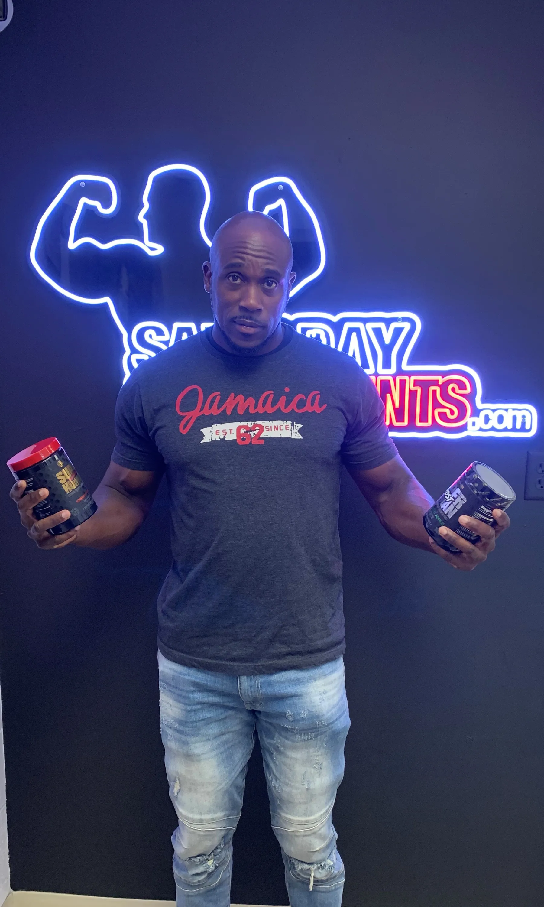 Customer holding two supplement bottles and smiling at SameDaySupplements