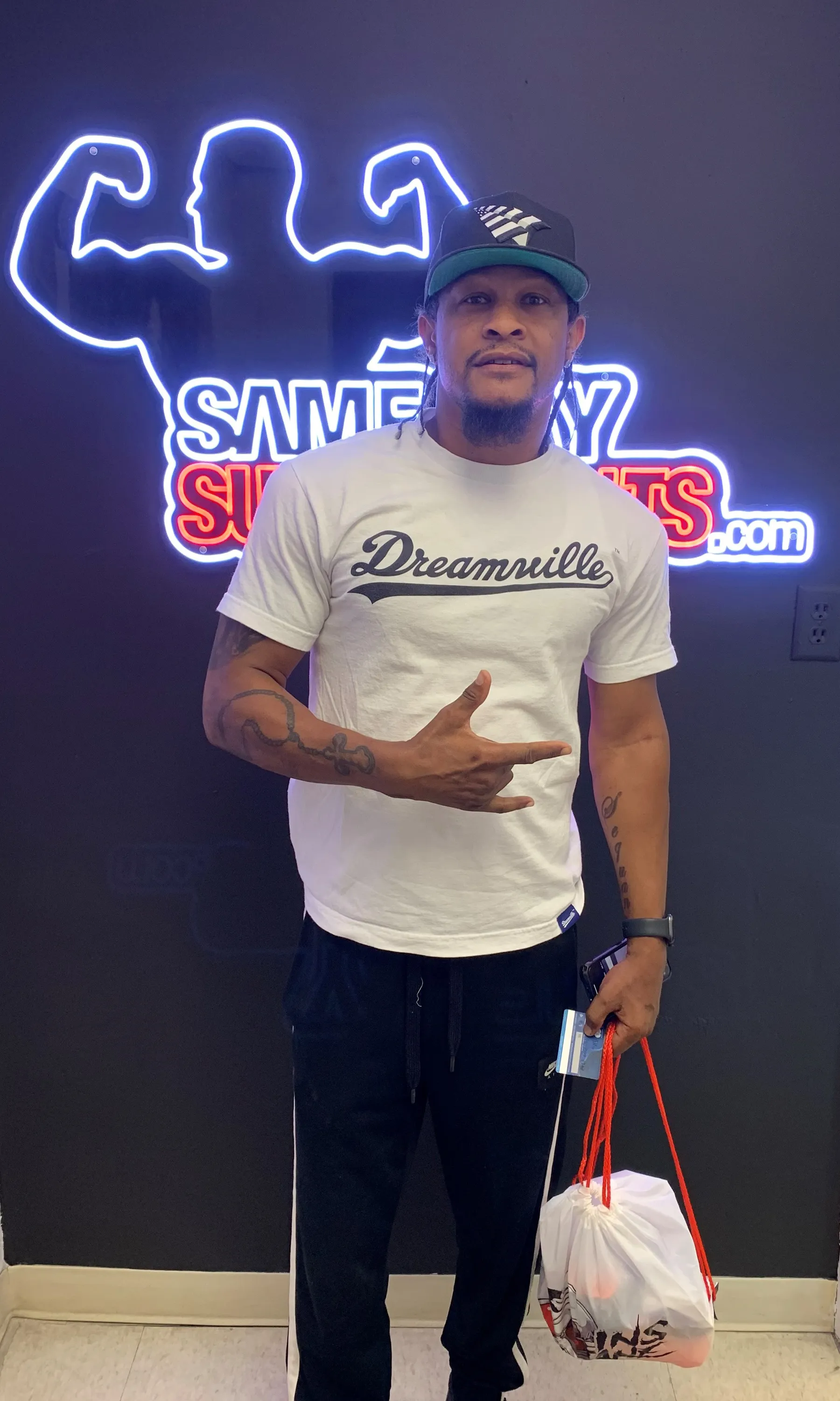 Customer with Dreamville shirt holding Insane Labz order