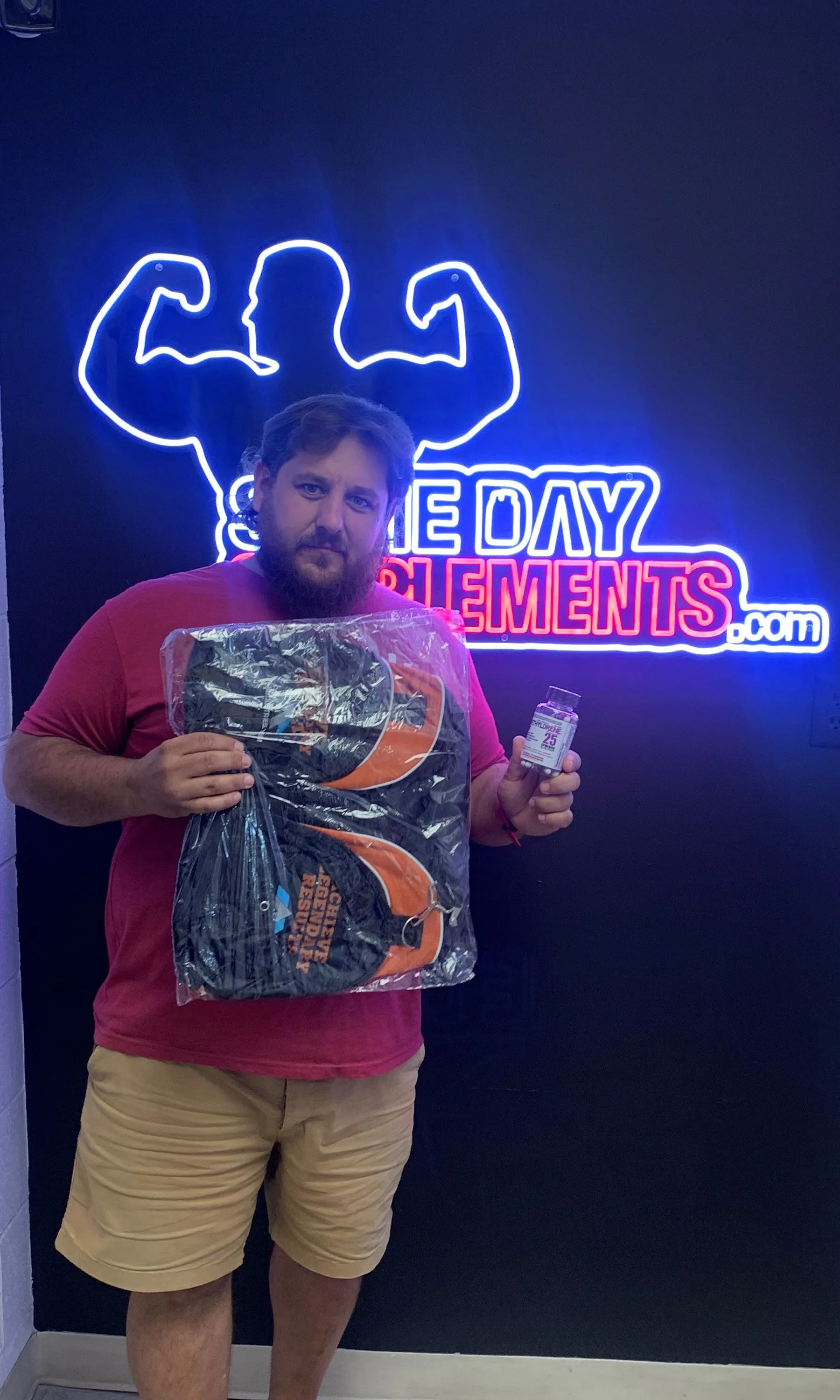 Customer holding Arms Race gift pack and supplements